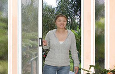 Woman Opening Screen Door, Window And Door Screens, New York, NY